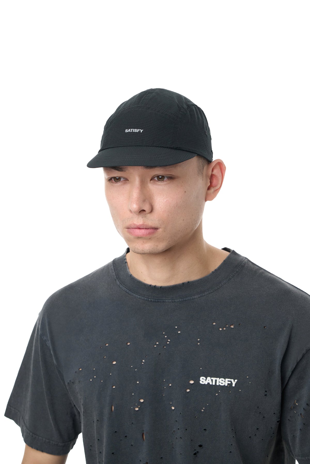 Satisfy Rippy Air Trail Cap in Black, worn on run